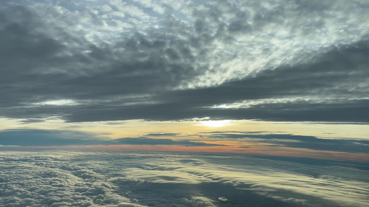 increíble cielo nublado al atardecer, fotografiado en el minuto dorado desde una cabina de avión volando hacia el oeste a 4000 m de altura cerca de valencia, españa