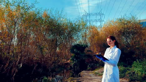 a young woman scientist at a creek, wearing protective eyewear and a lab coat