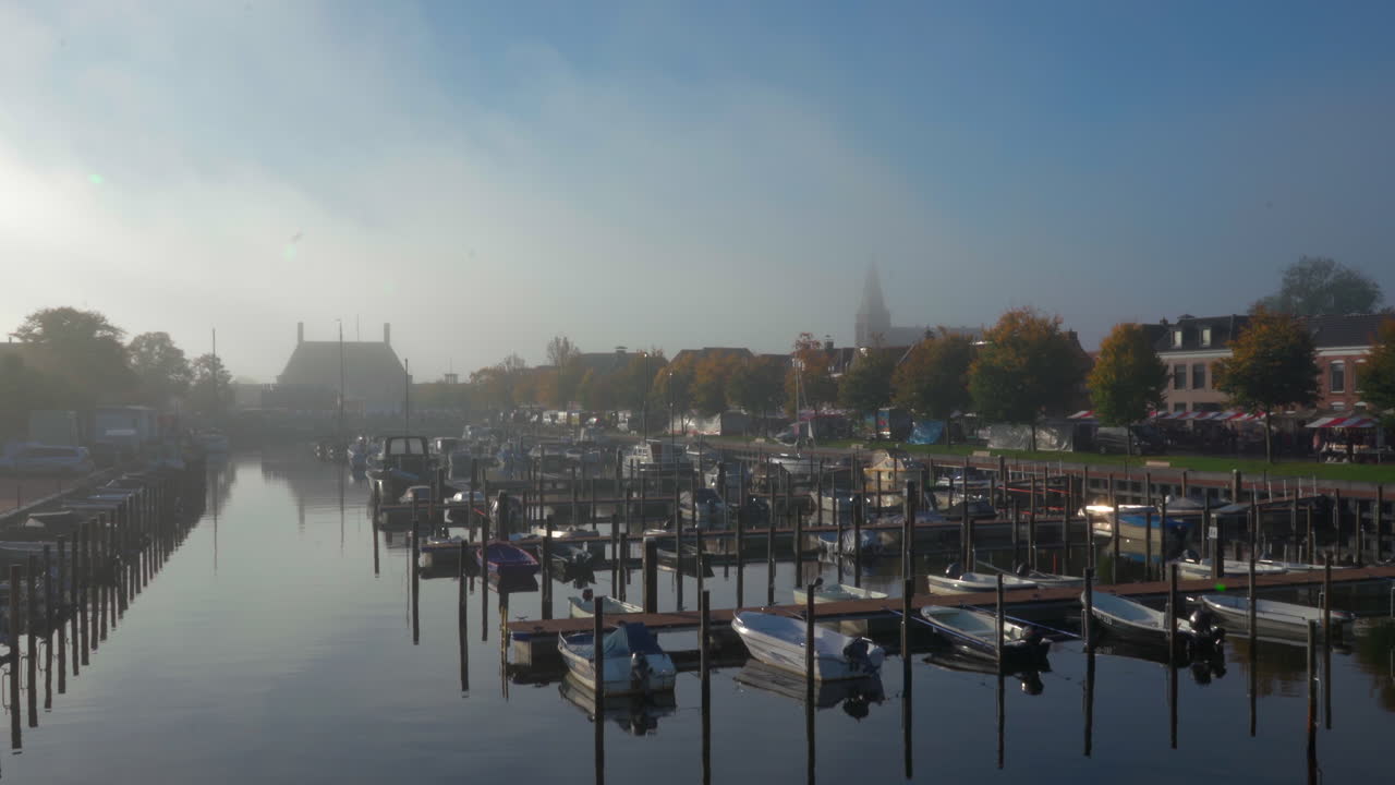 배와 배를 위한 전형적인 작은 만에 초점을 맞춘 화창한 겨울 아침의 평화롭고 조용한 네덜란드 마을 항구