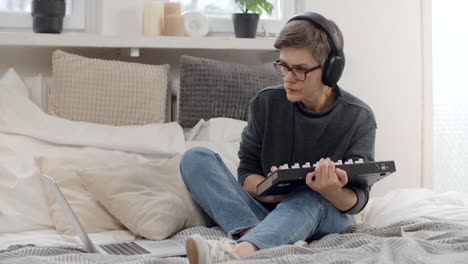 woman creating music in her bedroom home studio
