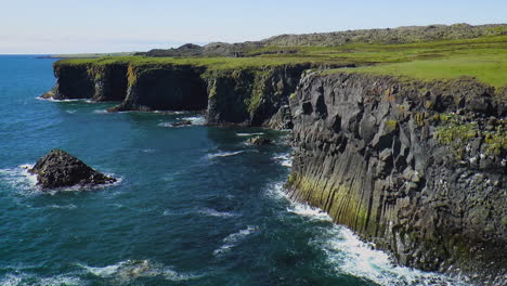 slow motion footage of sea waves on coast line with cliffs and rocks in arnarstapi village in iceland on snaefellsnes peninsula