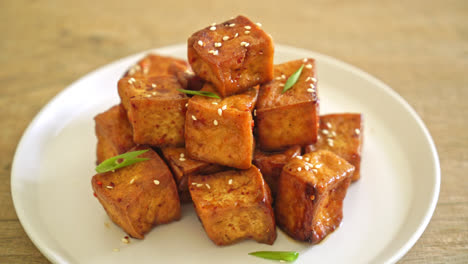 fried tofu with white sesame and teriyaki sauce - vegan and vegetarian food style