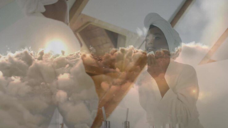 Animation of african american woman removing make up over clouds