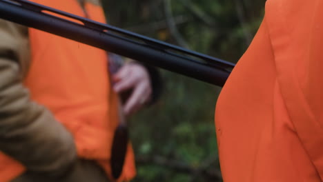 Two-hunters-wearing-blaze-orange-holding-hunting-rifles