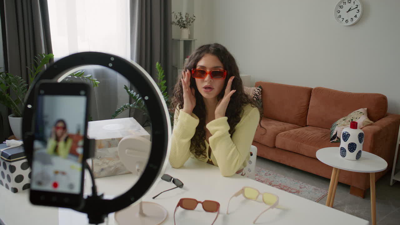 Female Blogger Trying on Sunglasses as Recording Fashion Review Video
