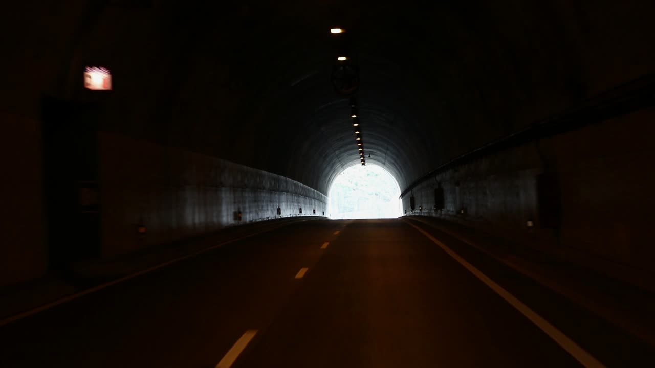The light at the end of the tunnel, travelling by car through a man made high way tunnel