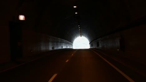 the light at the end of the tunnel, travelling by car through a man made high way tunnel