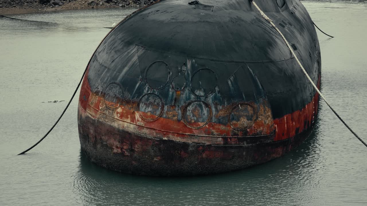 Old Rusty Submarine Hull Floating in Murky Water