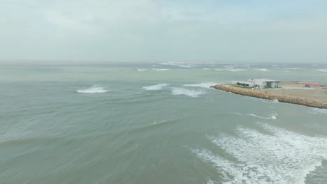 Aerial-view-of-Arabian-sea-waves-breaking-during-cyclone-Biparjoy,-High-tide-and-extreme-weather-at-coastline,-Pakistan,-Sindh