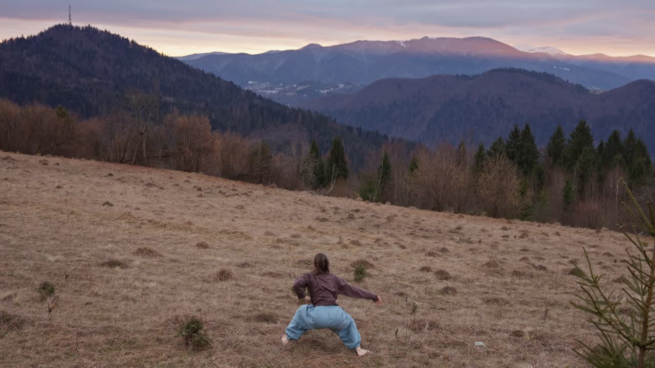 Woman in a field with a mountain background