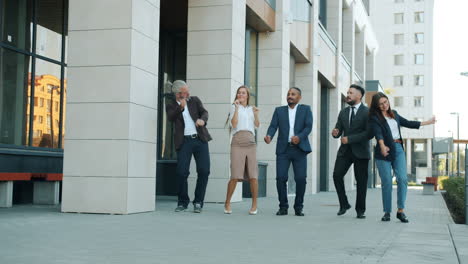 business team dancing outside the office