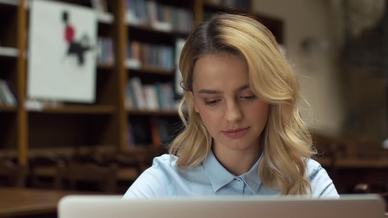 Woman Studying with Laptop in Library