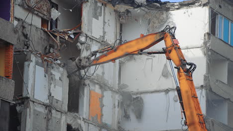 special machine destroys the house. demolition excavator destroys an old building