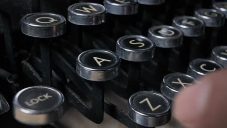 Operating-a-vintage-typewriter-from-the-1920s,-pressing-the-keys-to-command-the-strikers-and-craft-a-document