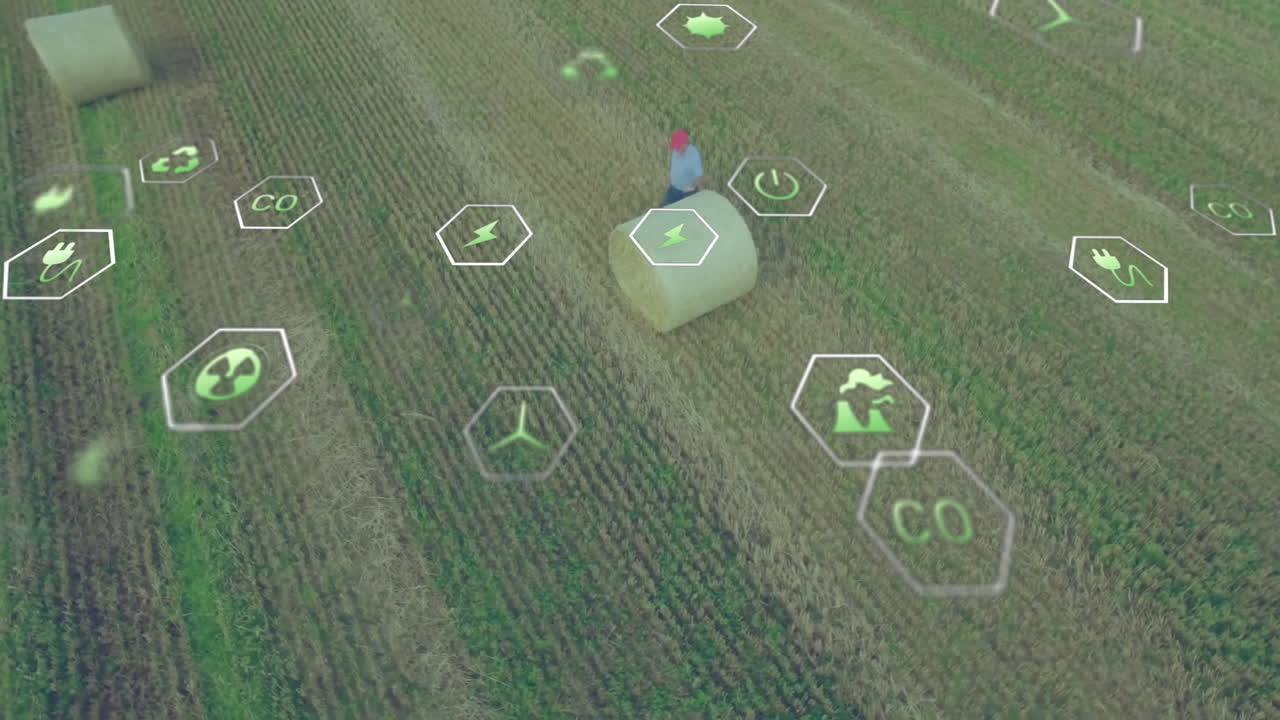 Mature man examining hay bale in harvested field, showcasing hexagonal renewable energy icons