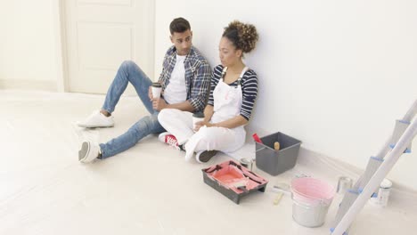 Young-couple-taking-a-break-from-renovating