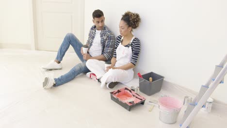 young couple taking a break from renovating