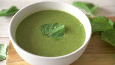 spinach soup bowl on wood background