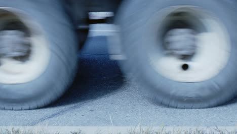 vehicle oil drops stain street asphalt as cars drive past, low angle