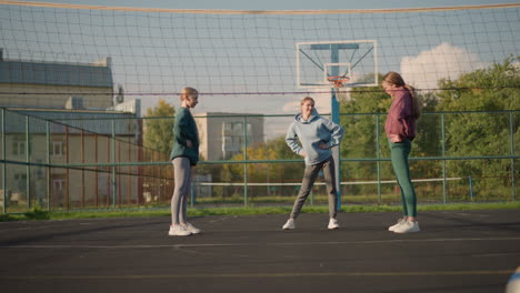 sporty women in activewear performing waist twist exercises outdoors in a sport arena, a vibrant and energetic scene featuring athletic movements with a volleyball court in the background