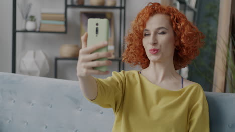 woman taking selfie on a couch