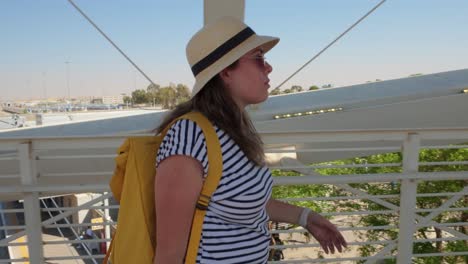 solo tourist heading to departure gate in bright sunlight