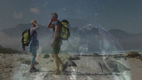 woman hiker and man hiker exchanging fist bump on rocky beach, with digital technology overlay