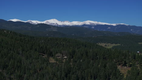 Cinematic-aerial-drone-first-snow-on-Mount-Blue-Sky-Evans-14er-peak-early-autumn-fall-beautiful-blue-bird-clear-morning-sunrise-day-Colorado-Rocky-Mountains-circle-righty-slowly-movement