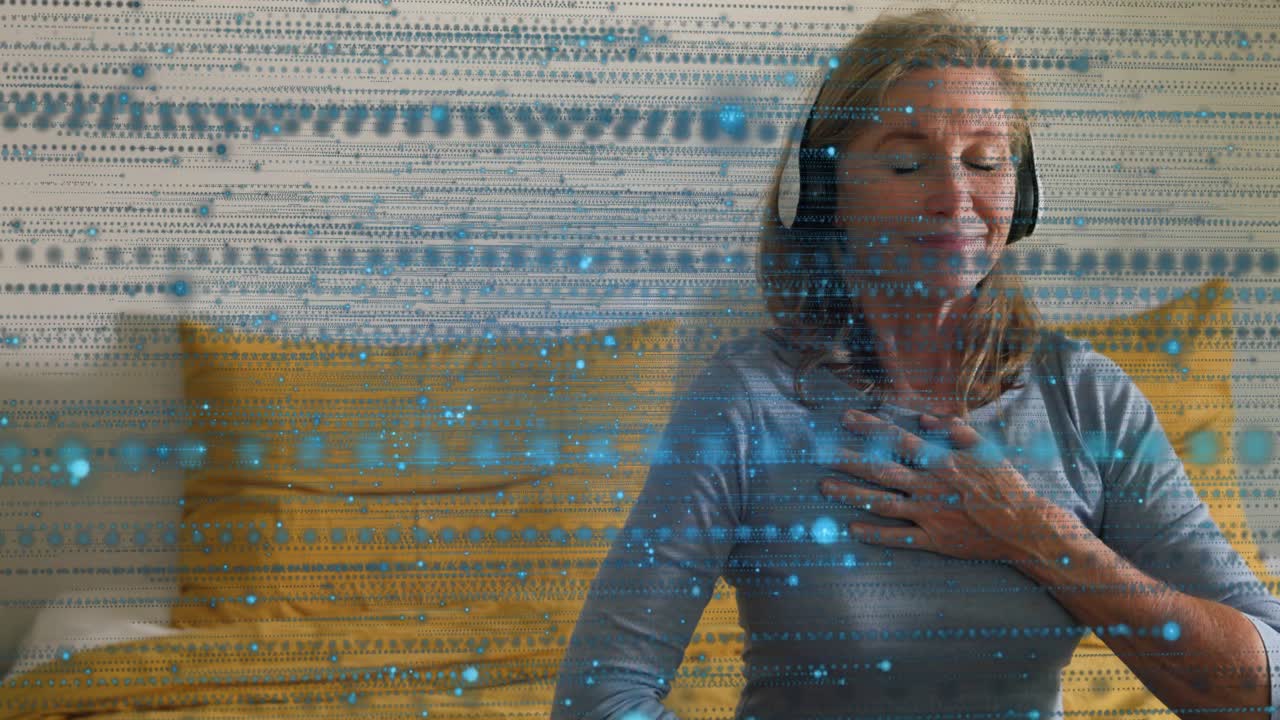 Woman sitting on bed hands on chest, abdomen after audio meditating, blue dots drifting around her