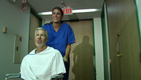 a nurse pushes a patient in a wheelchair