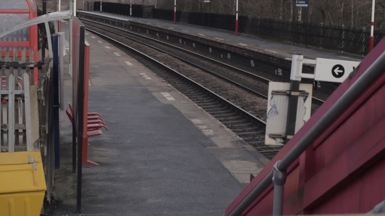 Empty railway station and train tracks in England