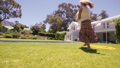 mother and daughter playing in backyard