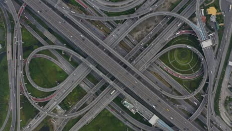 high angle looking top down view of complicate road and expressway intersection in bangkok city of thailand. shot by drone can use for transportation or abstract concept.