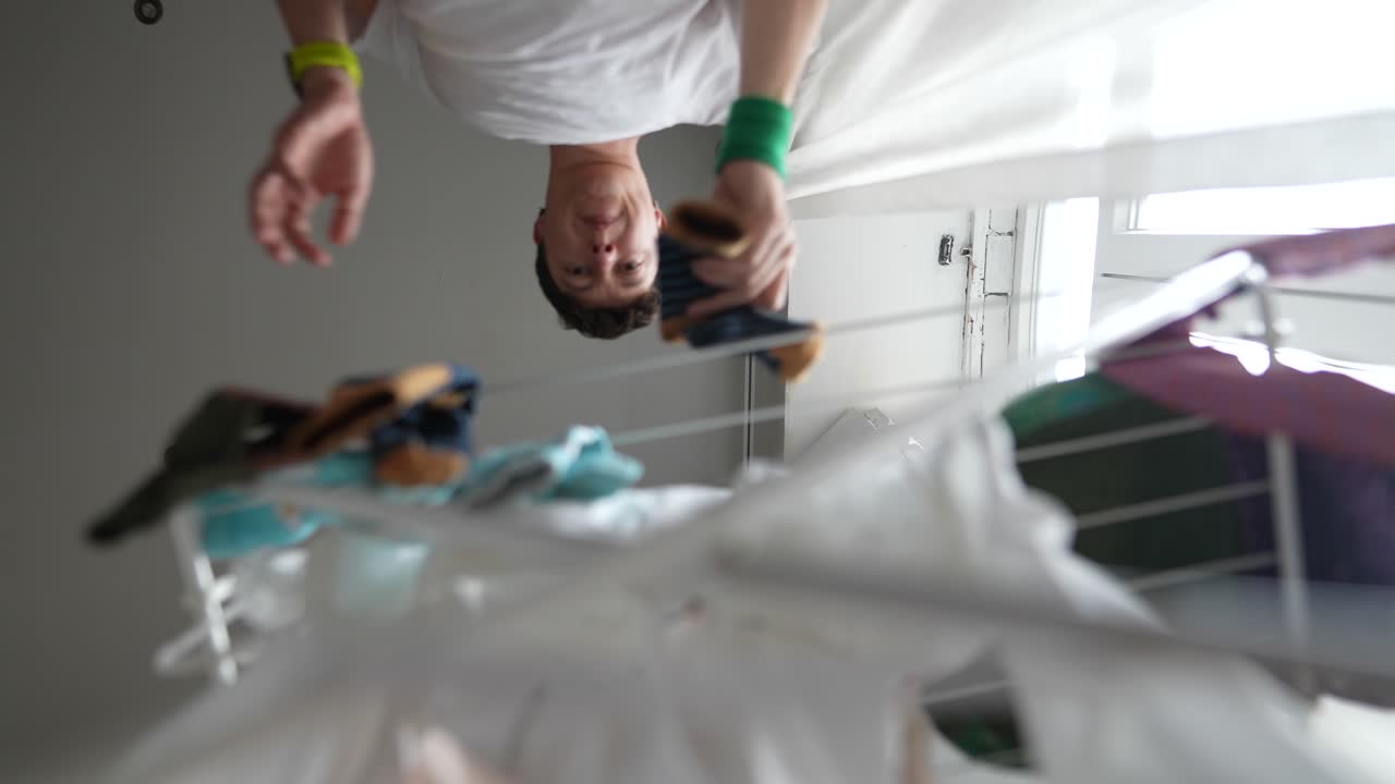Person Drying Clothes on a Rack