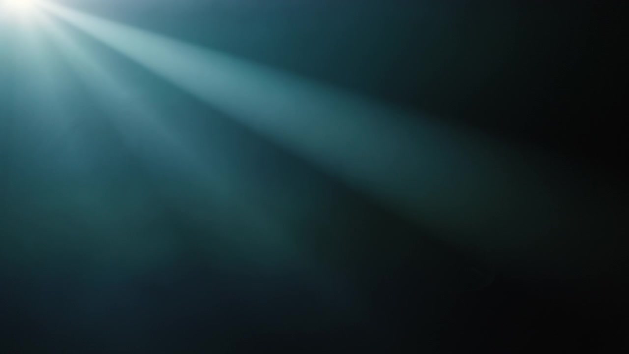 Moving Light Rays and Lens Flare on Dark Background