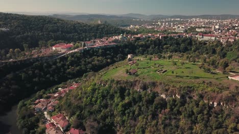Forward-tilting-drone-shot-over-a-hill-with-an-archeological-site-in-Veliko-Tarnovo