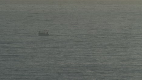 Fisherman going with his boat far from the coastline very fast at costa brava shot with a vintage lens