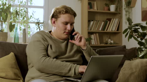 Young-blond-boy-sitting-on-the-sofa