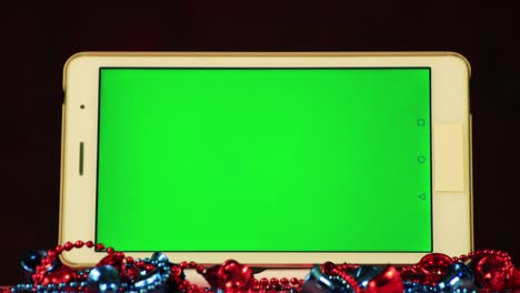 white tablet close-up with green screen for insertion.