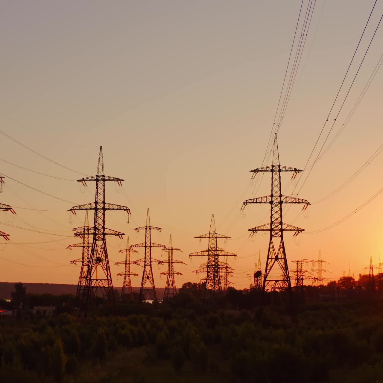 High voltage electric towers at sunset. Transmission power line. Parts of electrical equipment and high voltage power line insulators in the evening.