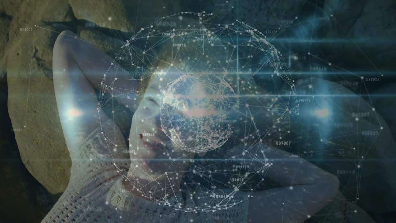 Woman lying on rock, camera framing above initiating 3D globe forming over forehead, showing tech