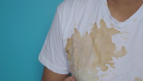 coffee stain on white v-neck shirt