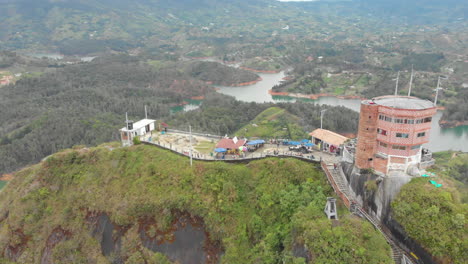 rock of guatape with viewing point on top, tourist site of colombia - aerial drone shot