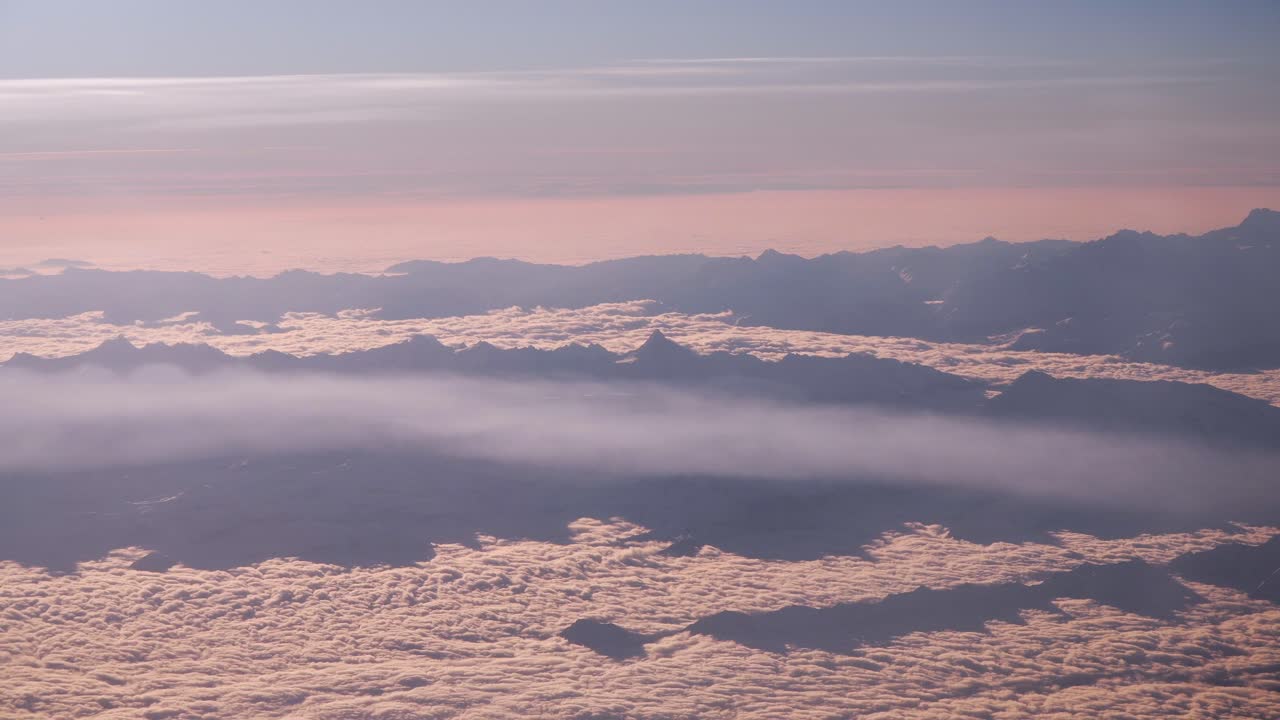 Plane flight in the morning over the alps, window view