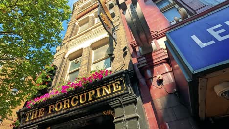 people gather outside a london pub