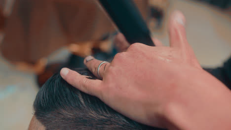 beautiful close-up detail of a classic haircut with scissors by a professional barber in a barbershop during the morning in 4k