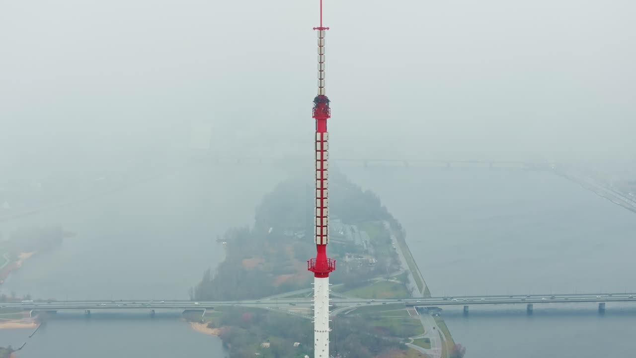 Soft mist surrounds broadcasting tower creating peaceful cinematic mood, Latvia