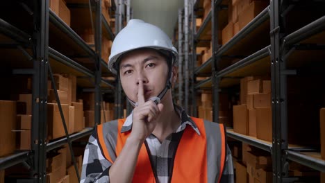 warehouse worker giving a quiet instruction