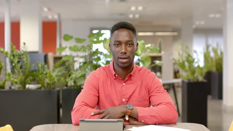 Portrait-of-casual-african-american-businessman-on-video-call-in-office,-slow-motion-with-copy-space