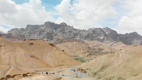 Road-crossing-through-amazing-huge-desert-like-mountains-in-INDIA